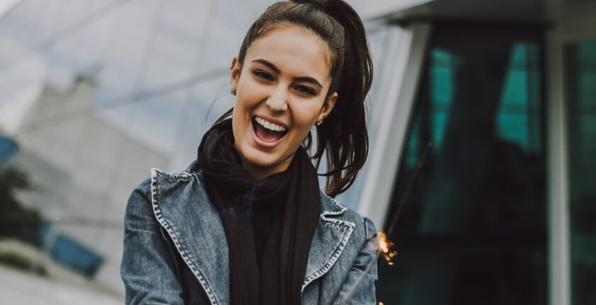 woman wearing gray denim jacket and black scarf